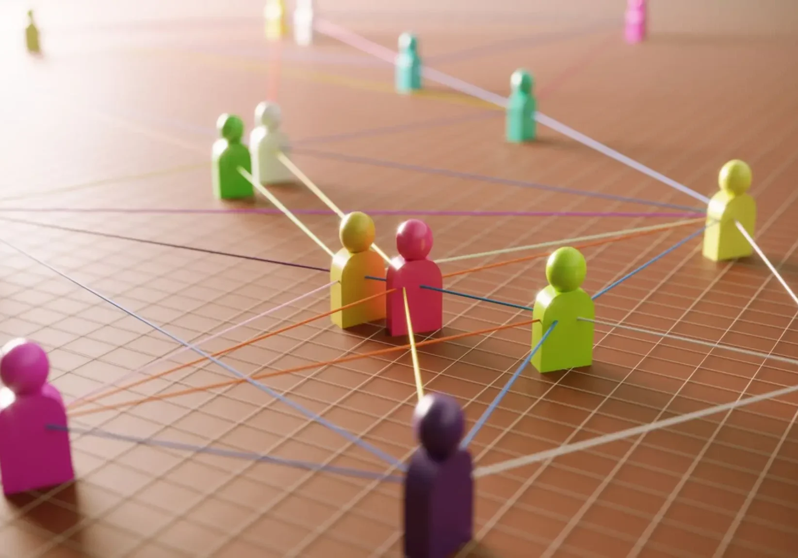 Colored figures connected by strings on a grid, symbolizing network connections.